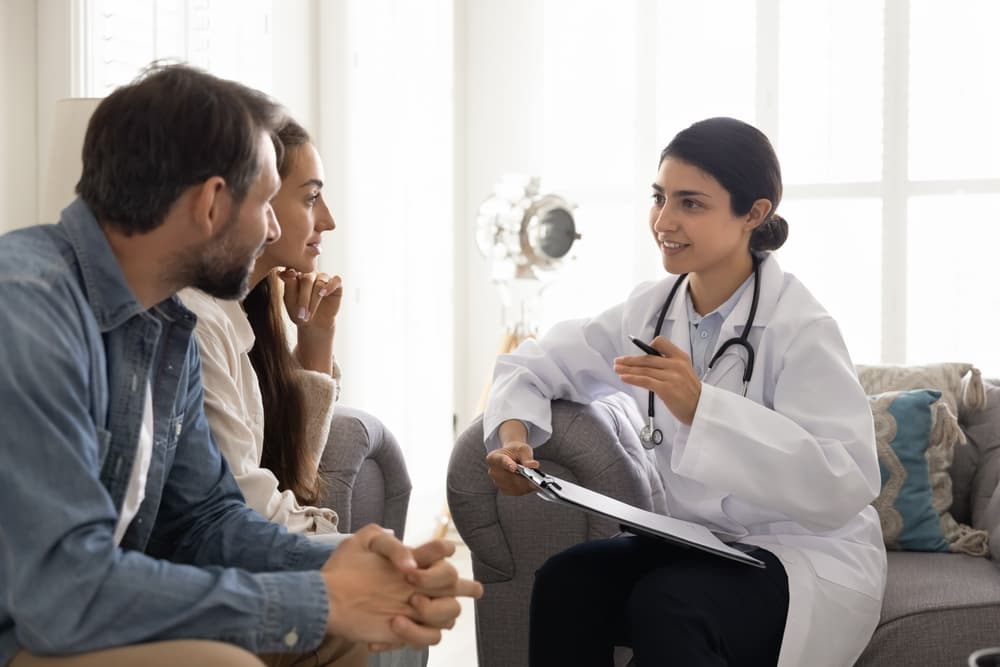 couple talking to doctor about insurance covering IVF